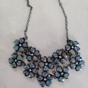 A floral necklace in sparkling shades of blue.